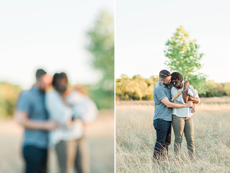 beautiful family of three standing in field 
