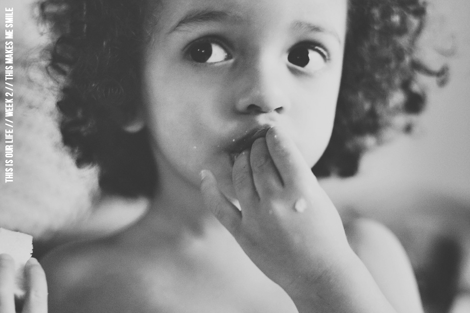 balck and white photograph of boy eating a sandwich