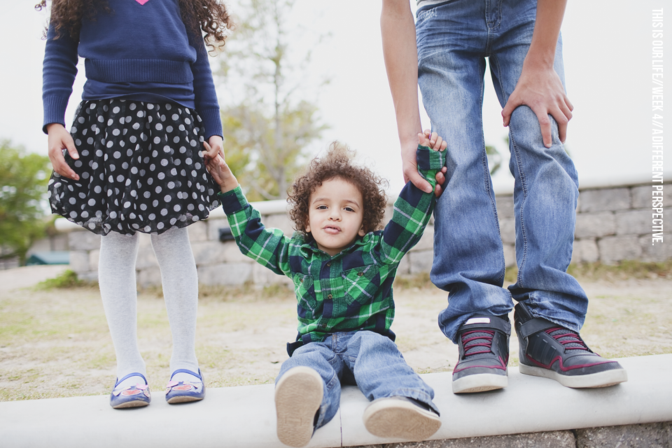 boy sitting on cement bench for photo