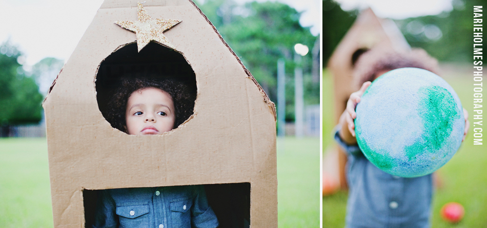 kid playing in backyard with rocket ship made of cardboard